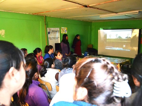 Las inmigrantes estuvieron atentos a la exhibici&oacute;n de un video educativo sobre el sistema penal en Chile.