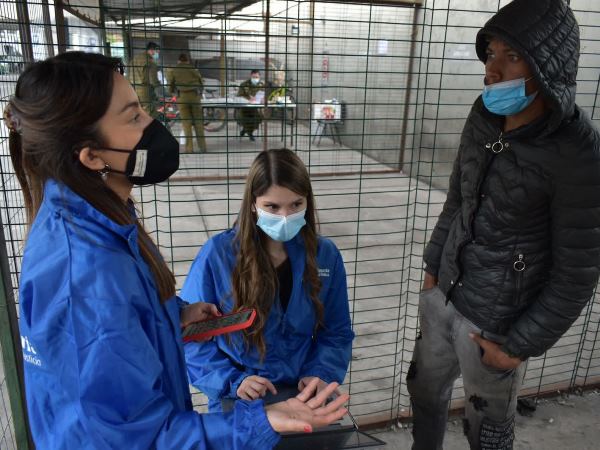 El equipo de defensa especializada de migrantes en plena atenci&oacute;n en el cuartel de Carabineros.
