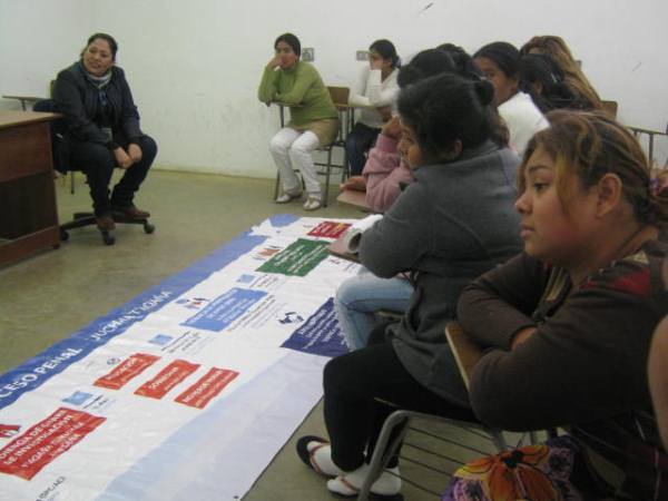 Las internas del penal de Alto Hospicio observan el panel did&aacute;ctico preparado en castellano y aymara.
