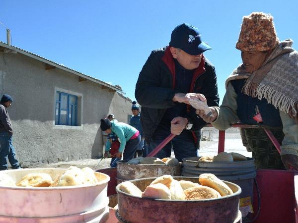 Do&ntilde;a Clementina escucha atentamente al Defensor Regional de Tarapac&aacute;, mientras recibe un folleto sobre defensa p&uacute;blica en lengua aymara.