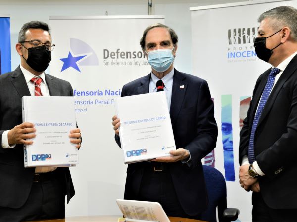 Carlos Mora (izquierda) al asumir el cargo, acompa&ntilde;ado por el ministro de Justicia, y por el saliente Defensor Nacional (s), Marco Montero.